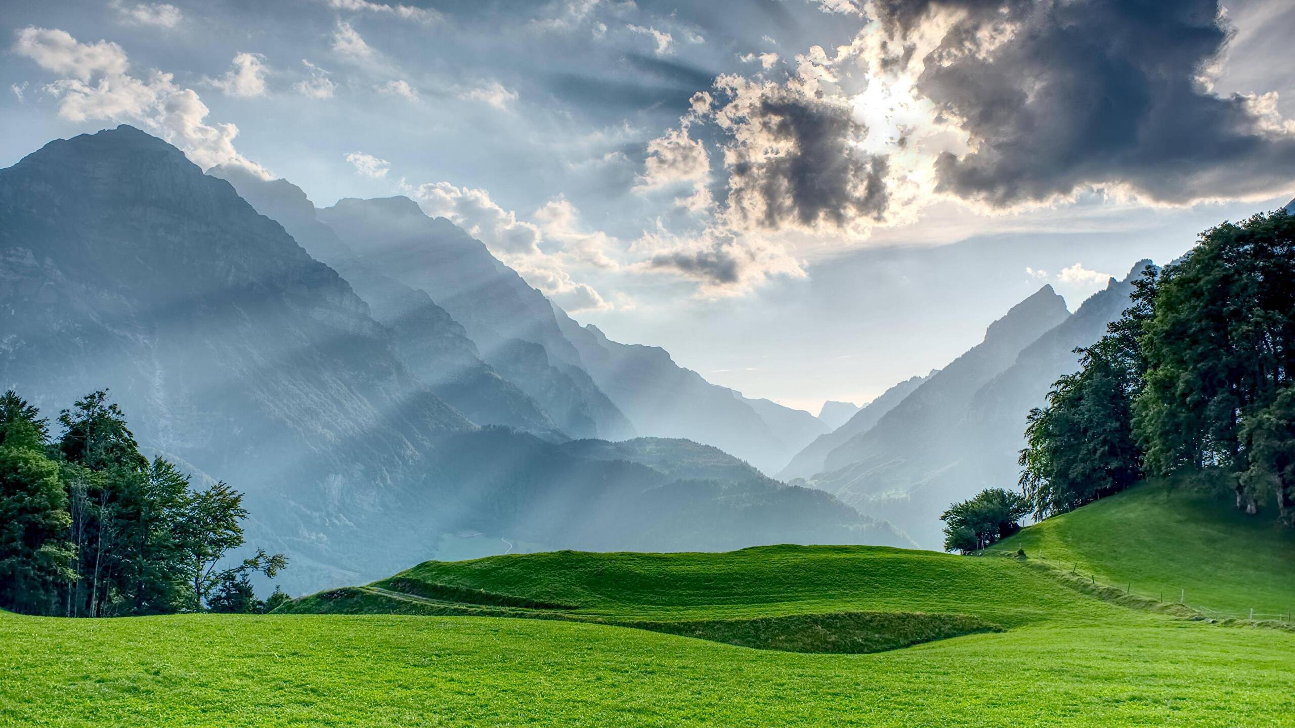 Sunlit green mountain valley